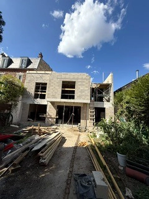 Vue d’ensemble du chantier à Villiers-sur-Marne depuis le jardin, avec maçonnerie et échafaudage