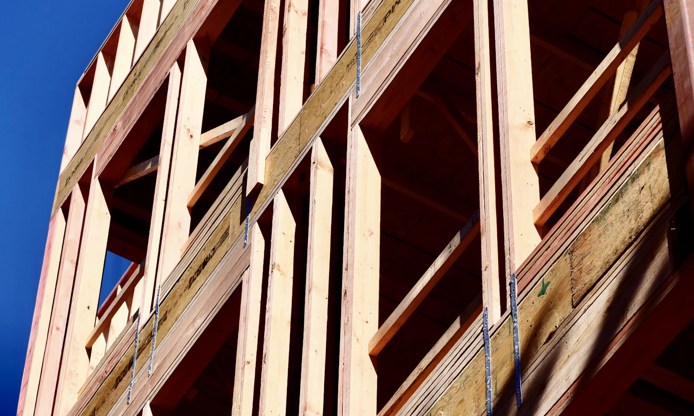 Ossature bois d’une maison sous un ciel bleu